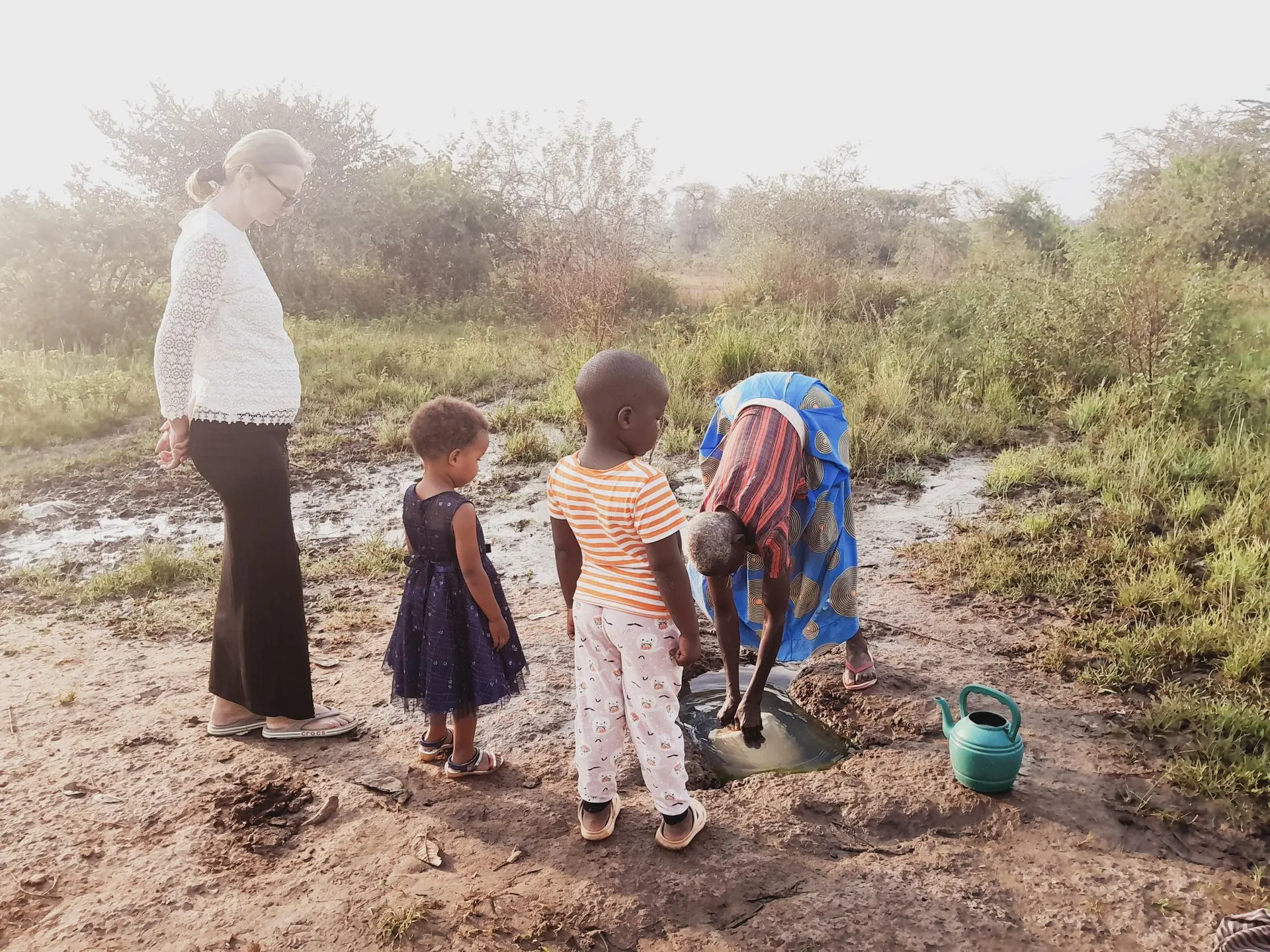 A volunteer helping children in a community setting